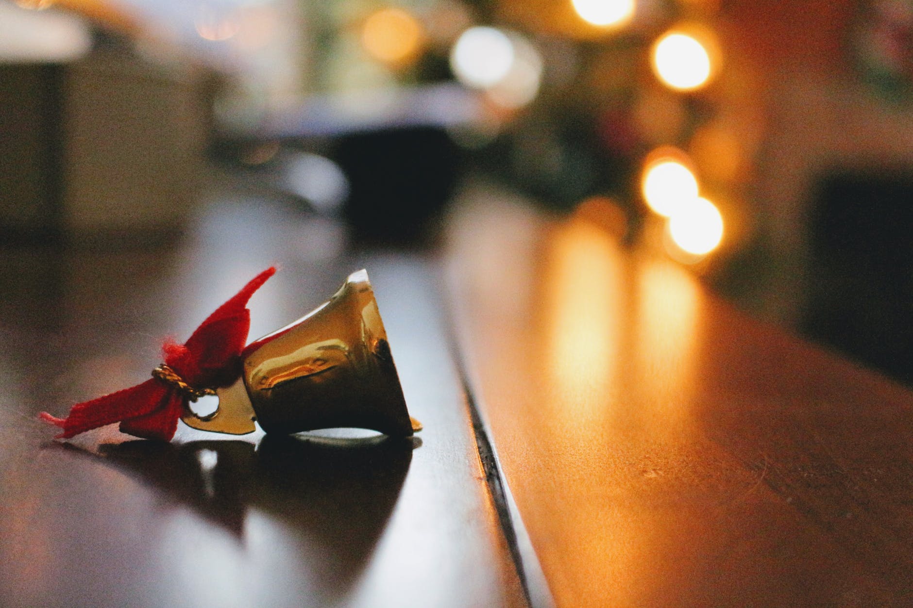 gold bell on top of brown table